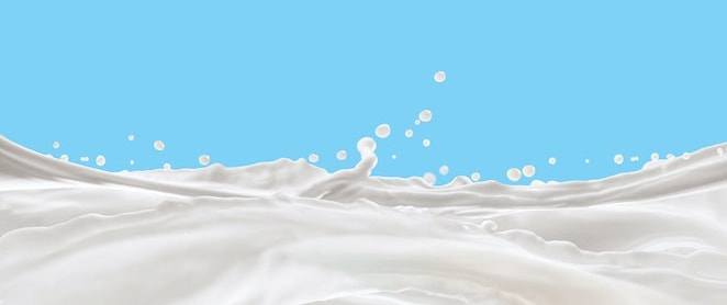 Milk Splash,splashing milk isolated on blue background